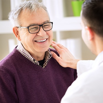 Smiling older man in dental chair