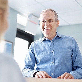 Smiling man at recpetion desk