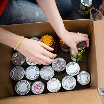 Person loading cans into box