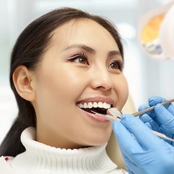 Woman smiling at her emergency dentist in Hampton