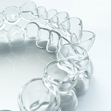 Closeup of clear Invisalign in Hampton on white background