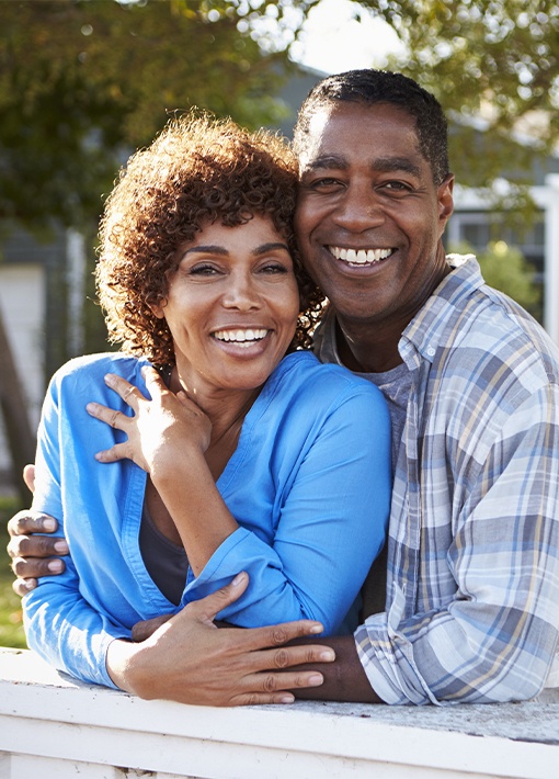 Smiling older man and woman outdoors