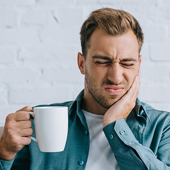 Man in pain holding jaw