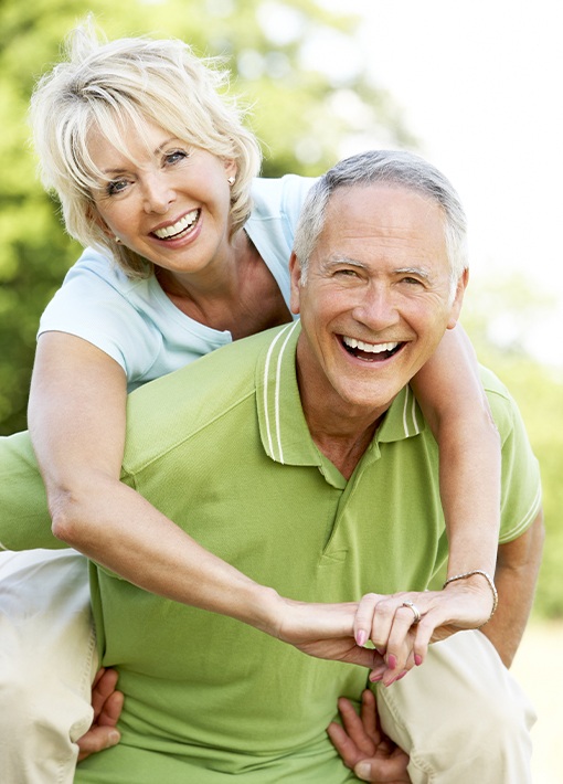 Smiling older man and woman outdoors