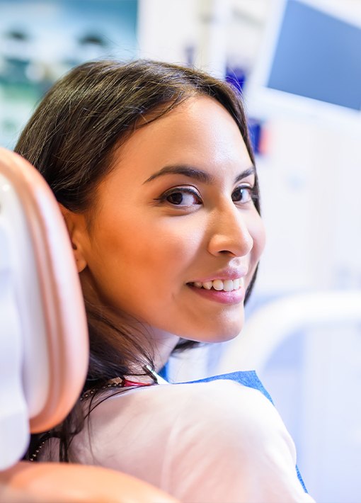 Woman in dental chair smiling