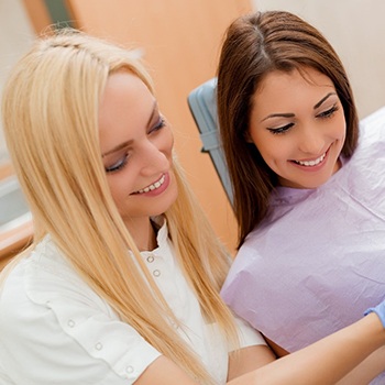 Dentist showing patient porcelain veneer shades