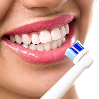 Closeup of patient brushing teeth