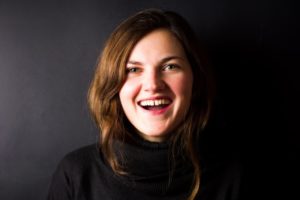 woman in black shirt with gap between front teeth