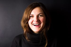 woman in black shirt with gap between front teeth 