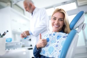 woman giving a thumbs up while visiting her dentist in Hampton