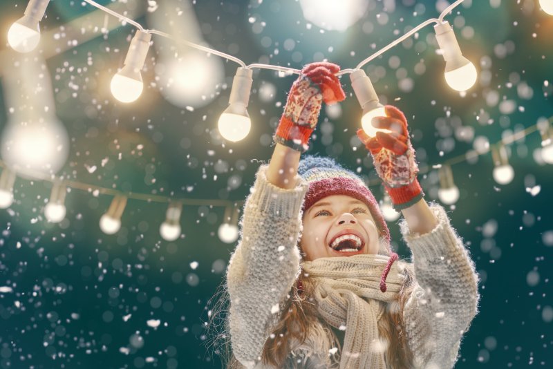 Young woman smiling and screwing in lightbulbs